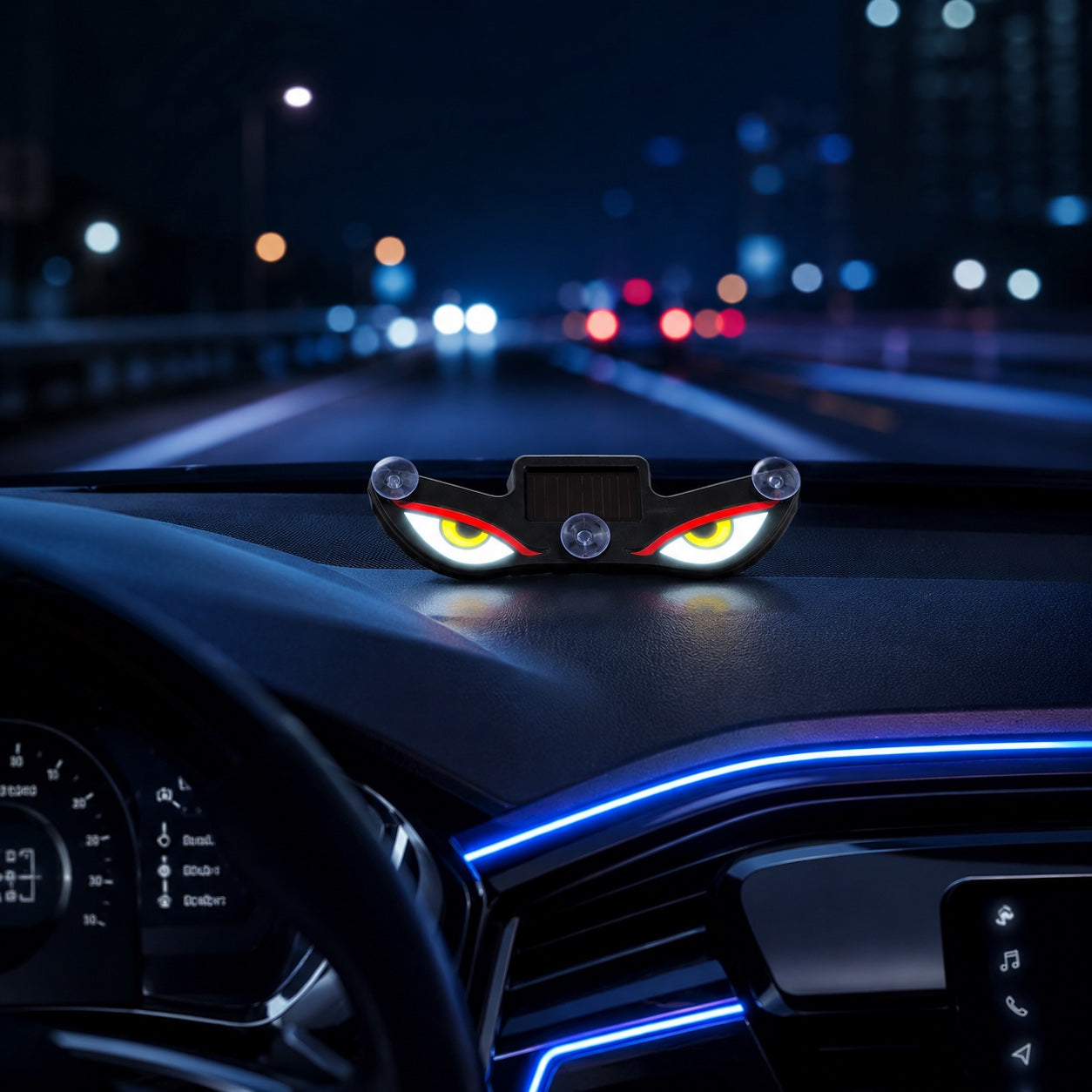Solar evil eye LED light displayed on a modern car dashboard during night driving