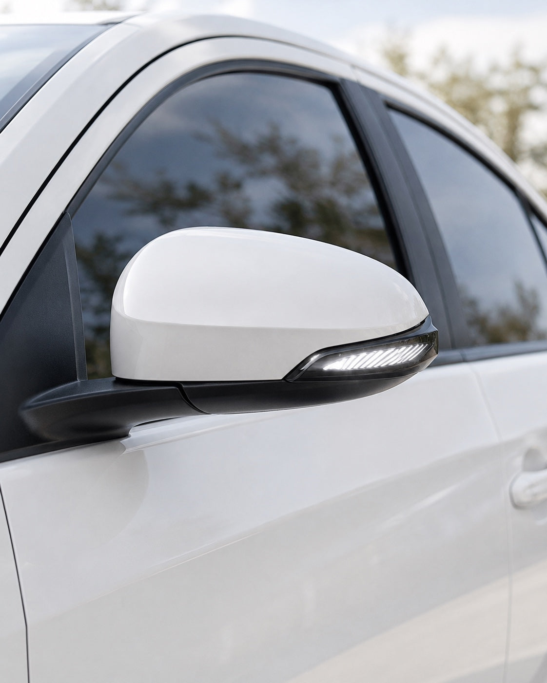 Wing style LED side mirror indicator showing white parking light on a Toyota car